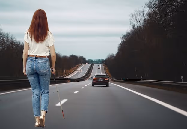 A driver carefully turning their head to check their blind spot while changing lanes