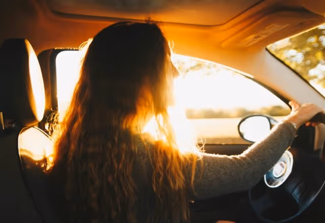 Learner driver at the wheel during their first driving lesson at sunset
